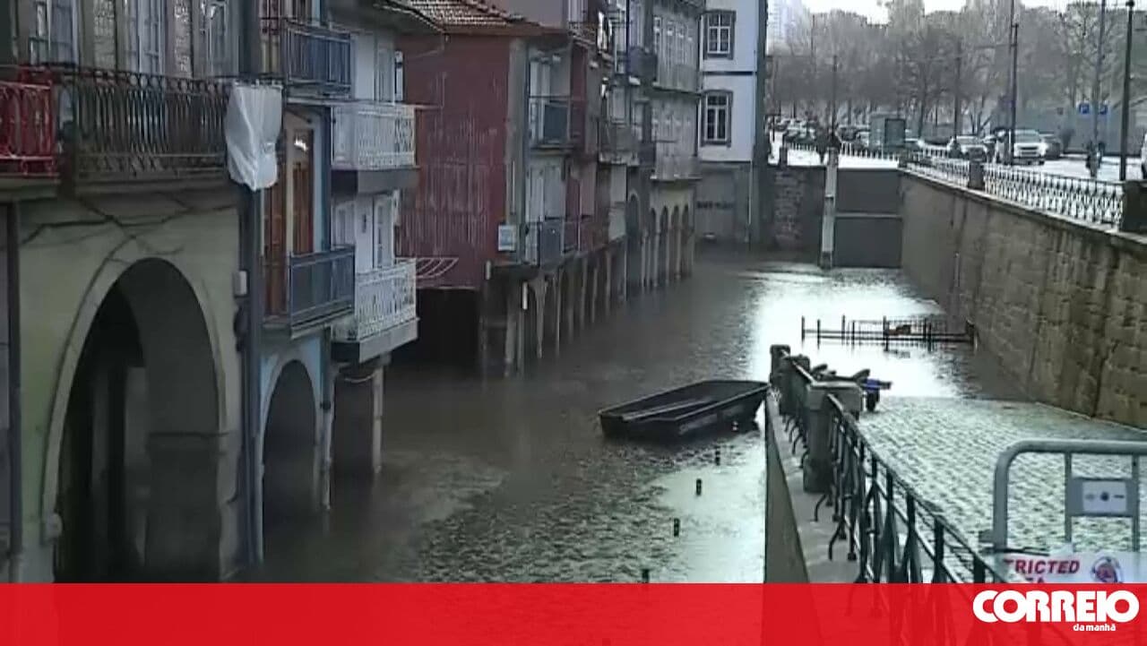 Porto firefighters place boat on flooded streets to help residents leave their homes in Miragaia