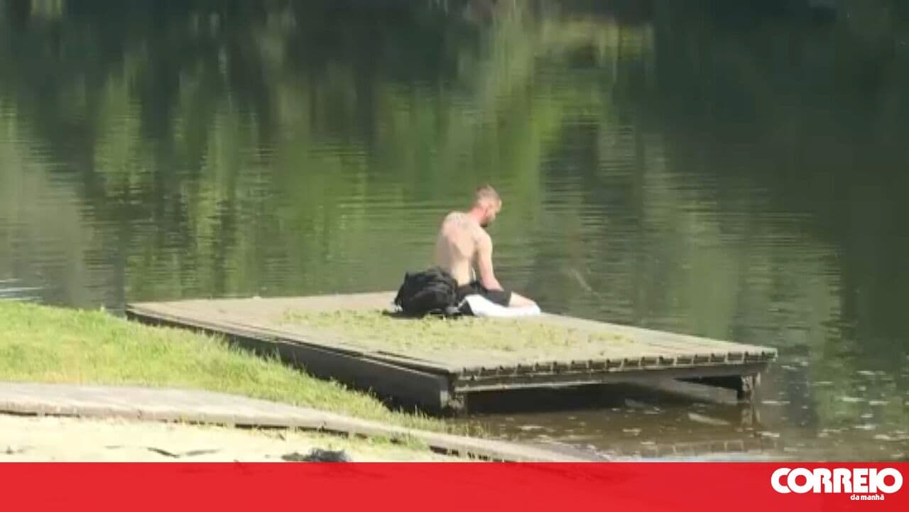 Bathers cool off by the river in Mirandela due to high temperatures