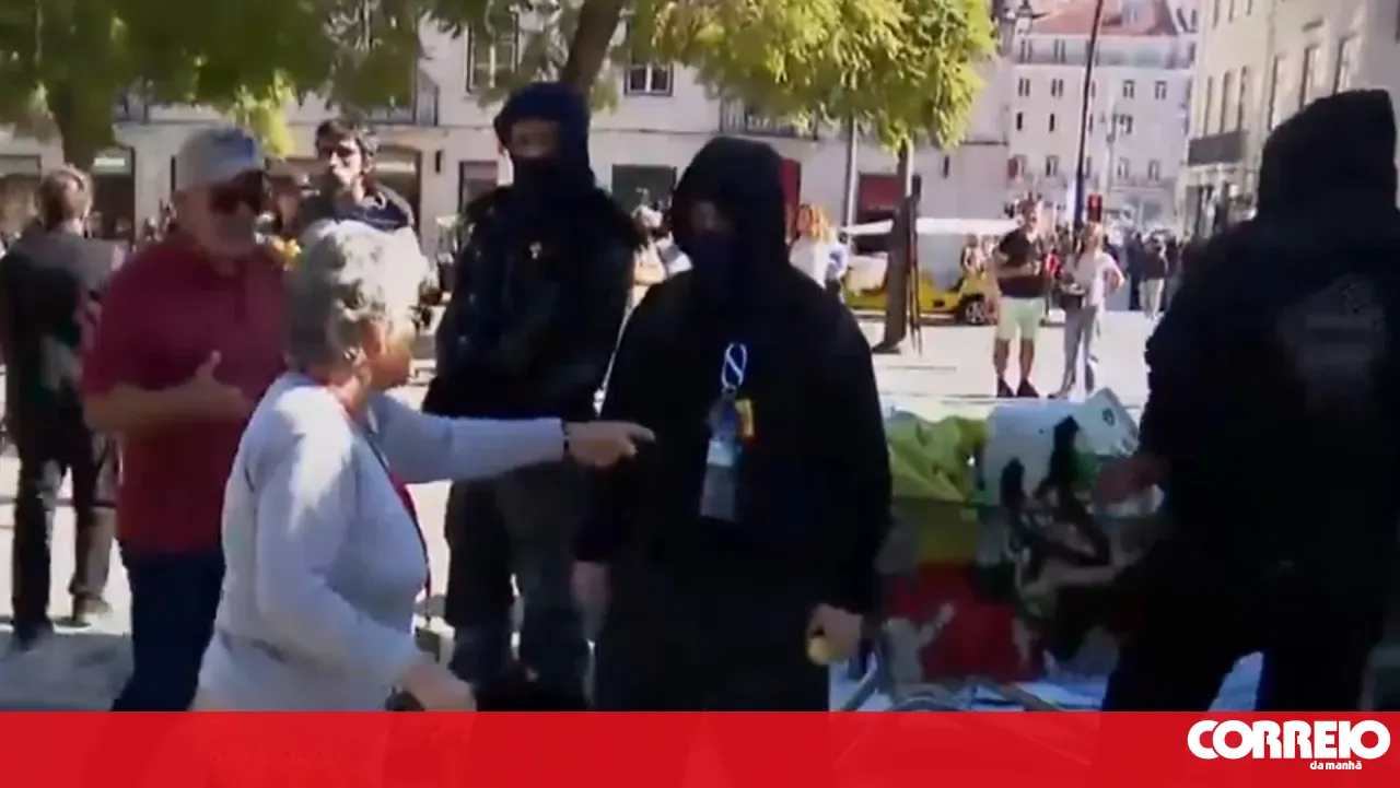"The people united will never be defeated": Protesters shout after argument with an elderly woman who disagrees with the protest
