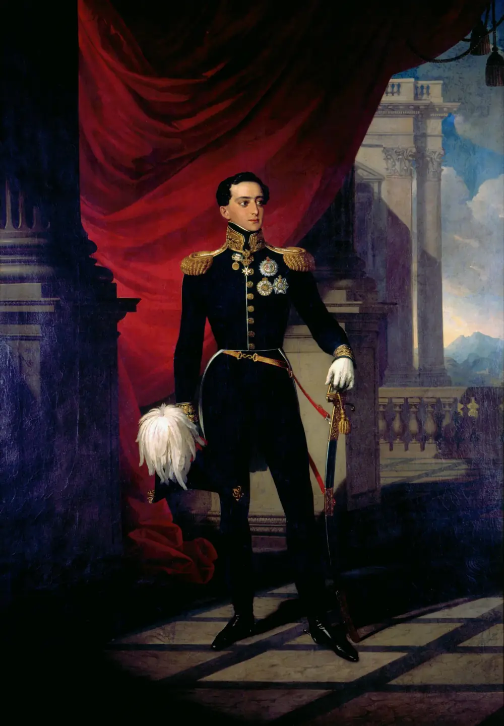 A full-length oil portrait of a slim young man with dark curly hair in a dark military tunic with gold epaulettes and collar, orders on his chest, white gloves, a sabre and a plumed hat, standing before a red curtain on a terrace with columns and mountains behind.