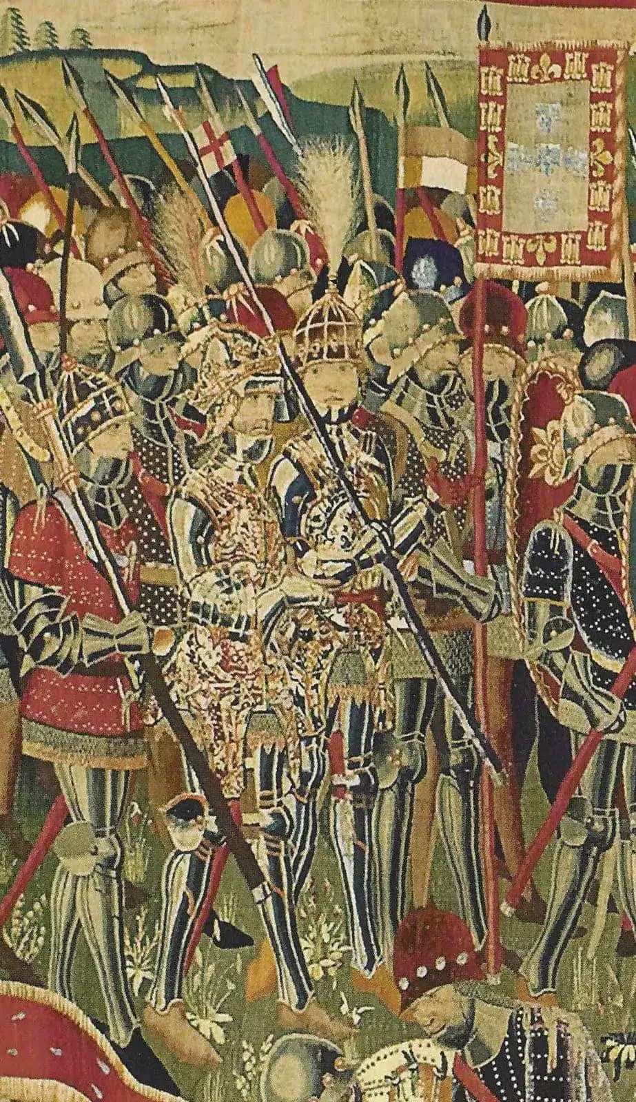 Close-up of a woven scene: armoured men in striped plate armour and plumed helmets crowd together with lances under a banner of the Portuguese royal arms. At the centre stand two richly dressed figures.