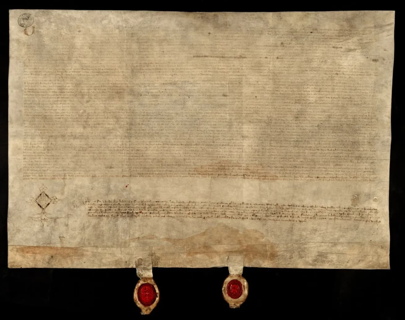A wide sheet of stained parchment covered in dense medieval handwriting, with two red wax seals hanging from strips at the bottom edge.