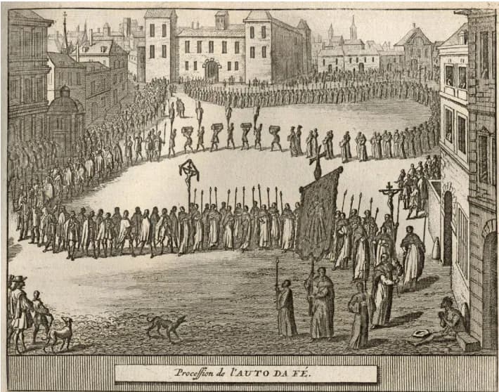 Engraving of a long procession winding across a town square: friars carrying tall candles, a crucifix and a large banner, penitents in tall caps, and men carrying boxes on their heads, with buildings behind. A label reads Procession de l'Auto da Fé.