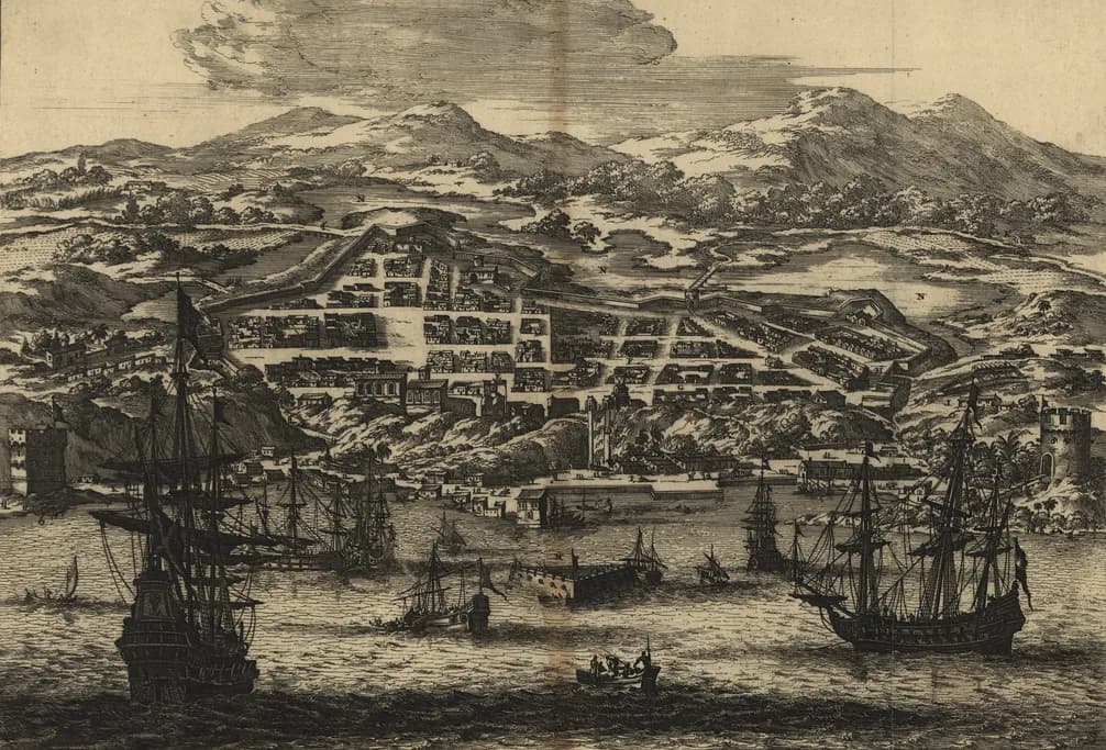 Engraved bird's-eye view of a hilly coastal town: a grid of streets and houses climbs from the shore, with forts at either end and tall sailing ships at anchor in the bay in front.