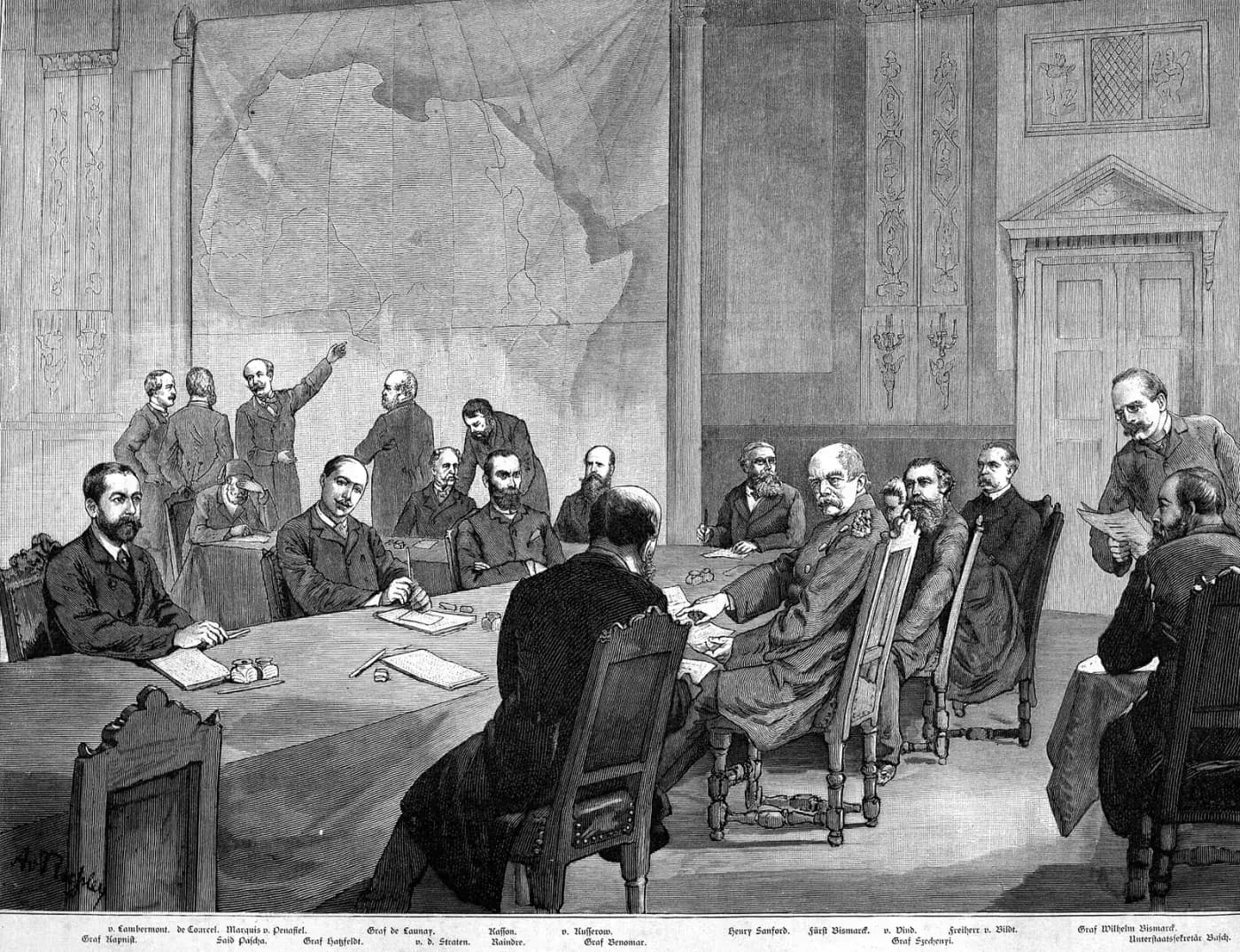 Engraving of about twenty bearded men in dark frock coats around a long table with papers and inkwells. Otto von Bismarck, in uniform, sits at the right-hand end of the table turning towards the viewer. Behind them a large map of Africa covers the wall, and a man standing beside it points up at it.
