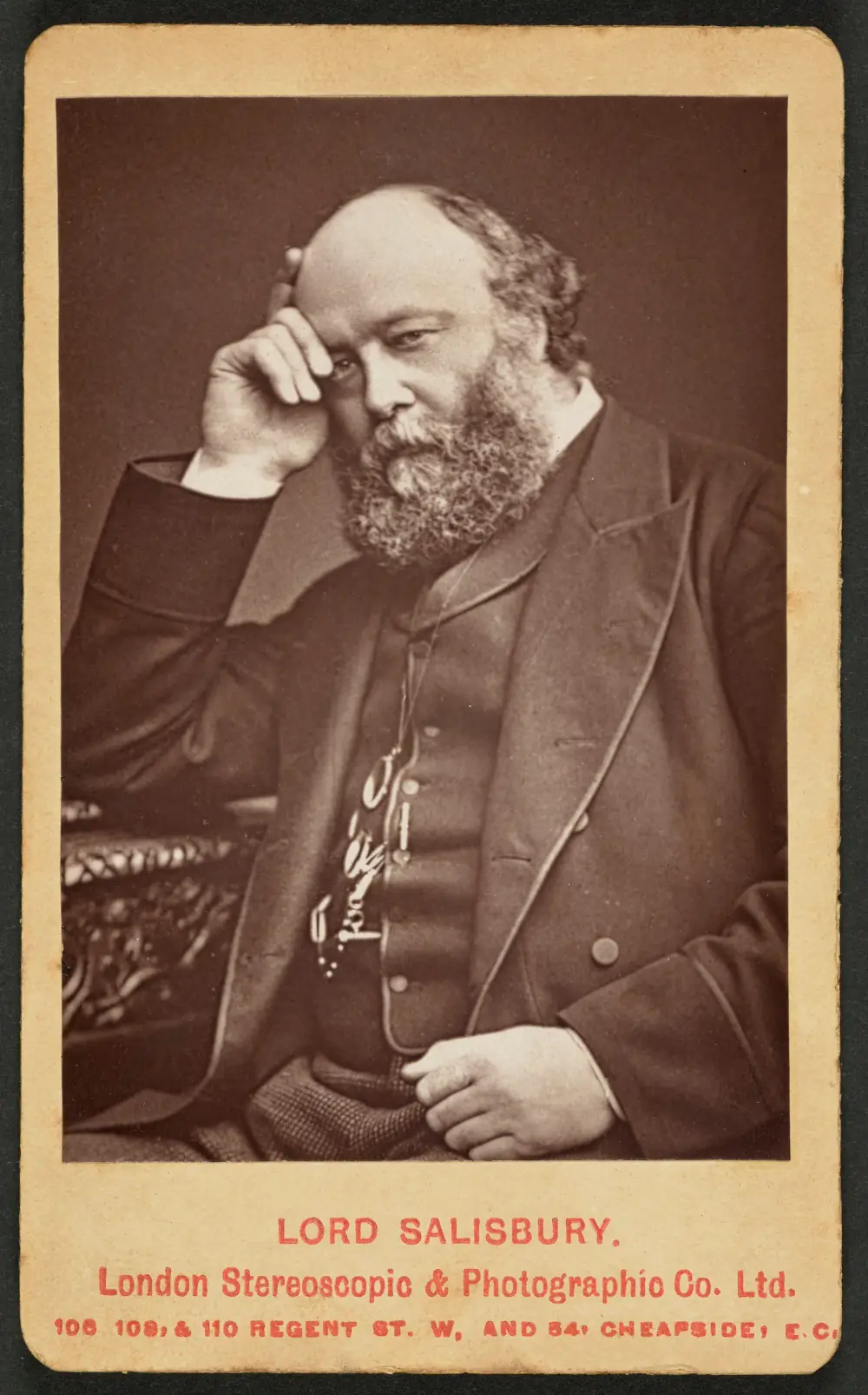 A sepia carte-de-visite of a heavily bearded, balding man in a dark suit and waistcoat, sitting with his head resting on his right hand. The mount is printed Lord Salisbury, London Stereoscopic and Photographic Co.