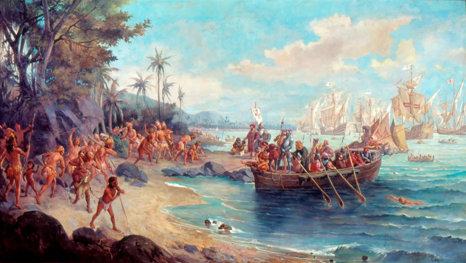 An oil painting of a tropical beach. On the left, Indigenous men with bows, spears and feather headdresses crowd the sand under palm trees; on the right, a rowing boat full of Europeans in armour and bright clothes, one holding a banner with a red cross, comes ashore. Several sailing ships with red crosses on their sails ride at anchor behind.