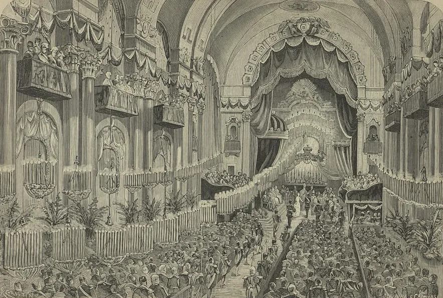 An engraving of a vast church interior hung with drapery and garlands, with galleries of spectators along both walls. Down a central aisle lined with seated guests, a small group in uniforms and a woman in white stand before an altar under a tall canopy.