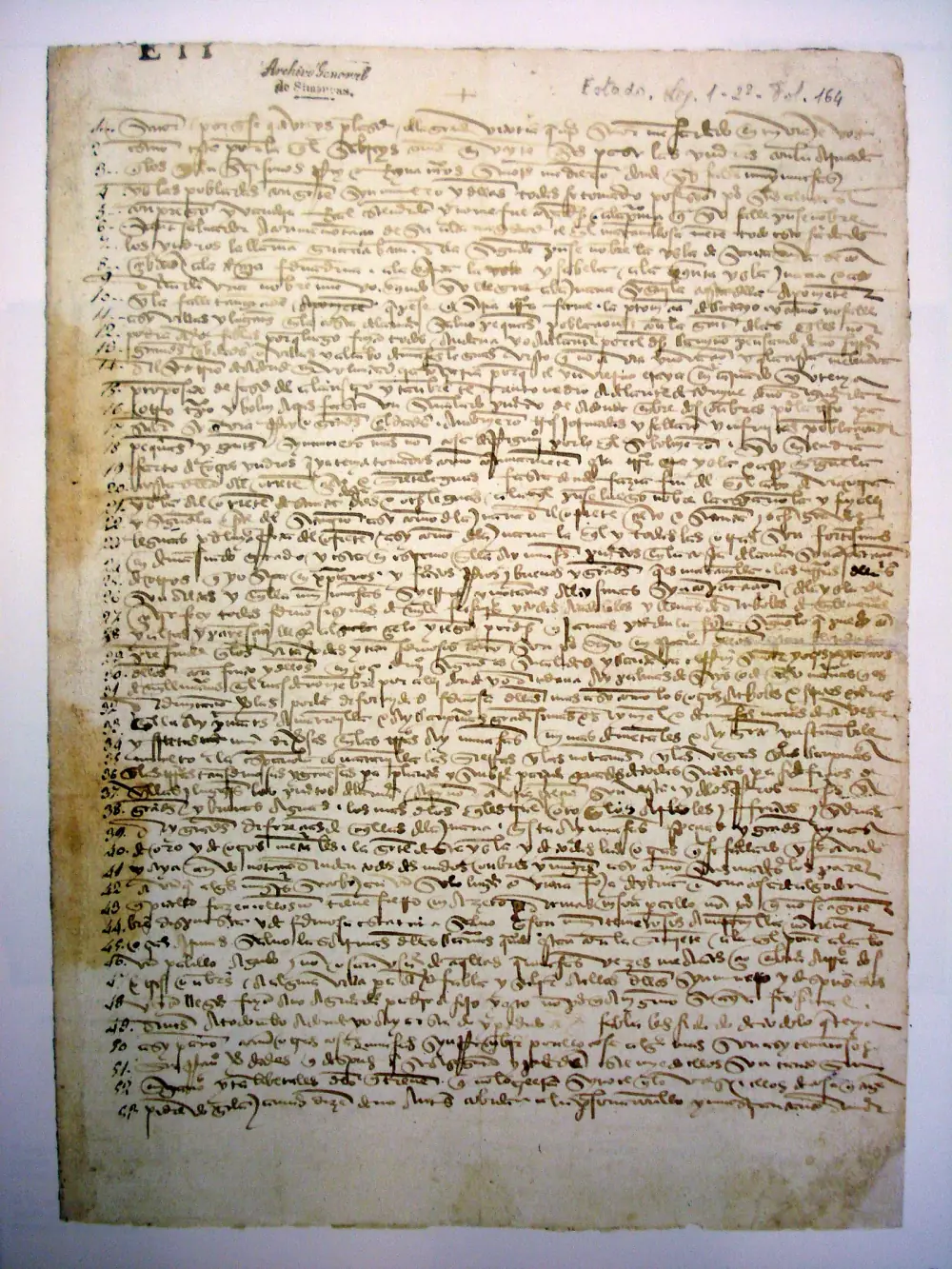 A single sheet of yellowed paper filled edge to edge with dense, heavily abbreviated fifteenth-century Spanish handwriting, with line numbers in the left margin and an archive note at the top.