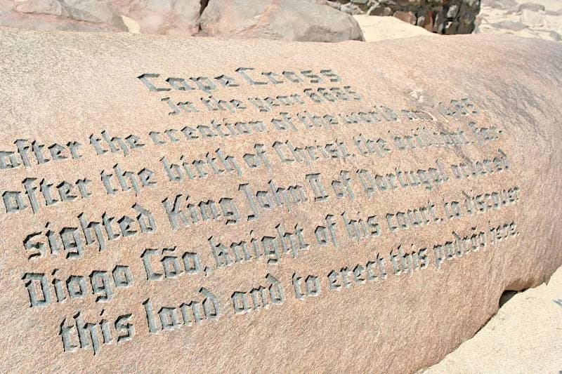 A large pinkish rock carved in Gothic-style lettering with an English text beginning Cape Cross, In the year 6685 after the creation of the world.