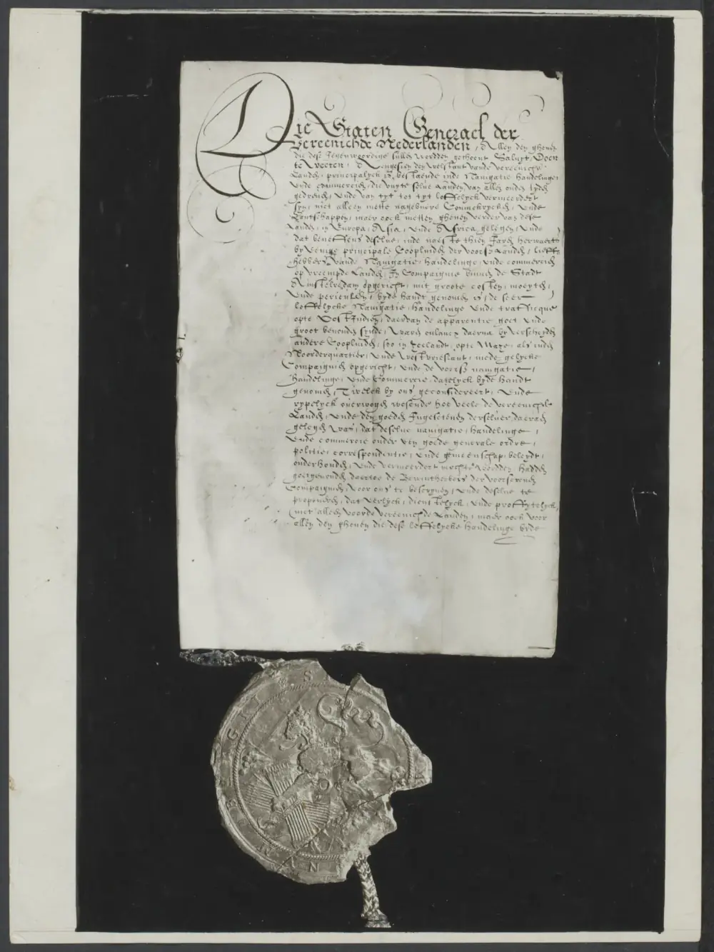 A handwritten page in ornate Dutch script, beginning with a large flourished capital, mounted on a black board; below it hangs a large, cracked wax seal on a braided cord.