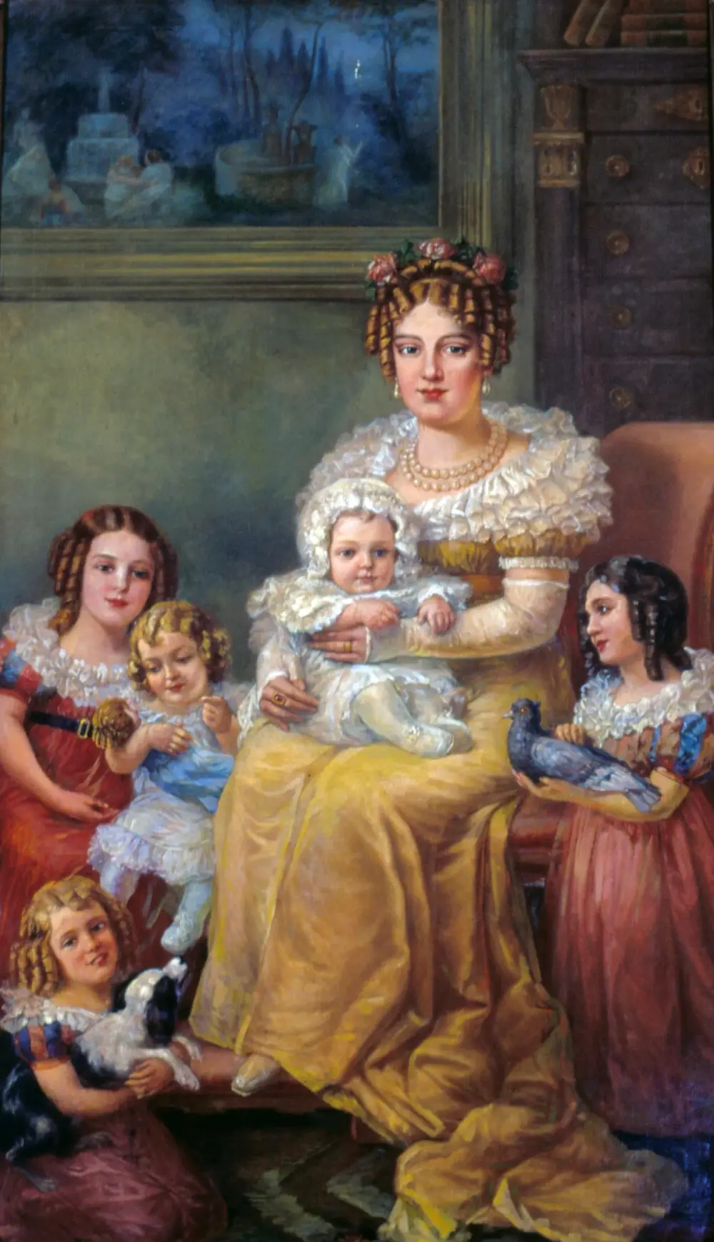 A seated woman in a yellow silk dress and pearl necklace, roses in her curled hair, holds a baby in a white bonnet. Four girls in ruffled dresses surround her, one holding a grey pigeon and another a small black and white dog.