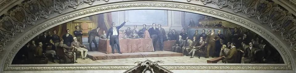 A wide arched painting of a crowded assembly hall, where men in early nineteenth-century dress sit in rows while a speaker stands with one arm raised beside a table covered in red cloth.