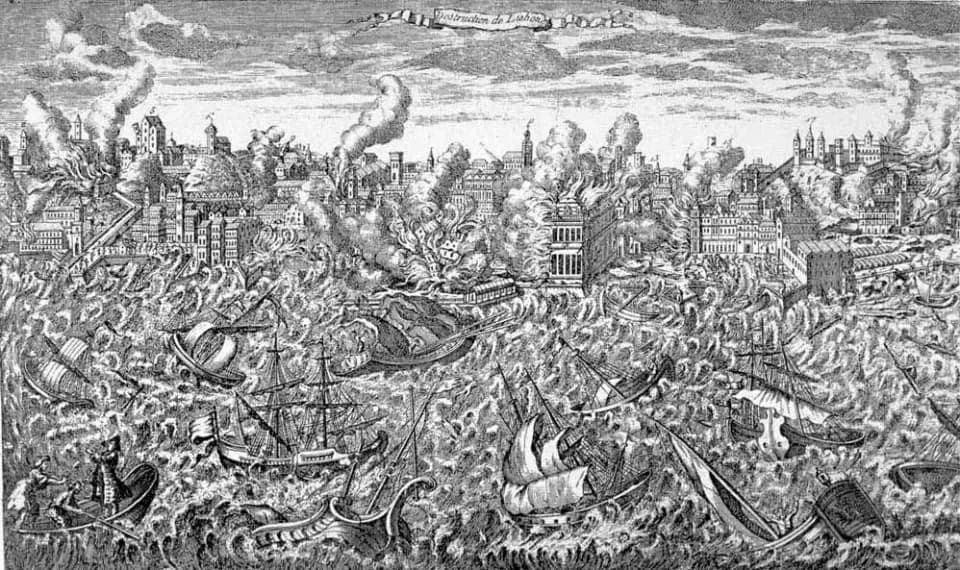 Black-and-white engraving of a city in flames and collapsing, with huge waves tossing ships in the harbour in the foreground.