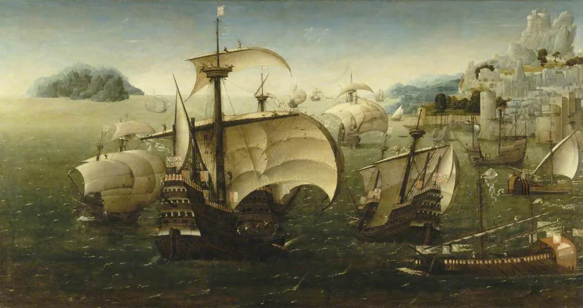 An oil painting of a fleet of tall sailing ships with high wooden castles at bow and stern, their square sails billowing over a green sea. Flags with the Portuguese arms fly from the masts, a long oared galley runs along the lower right, and a walled town climbs a rocky hill on the right.