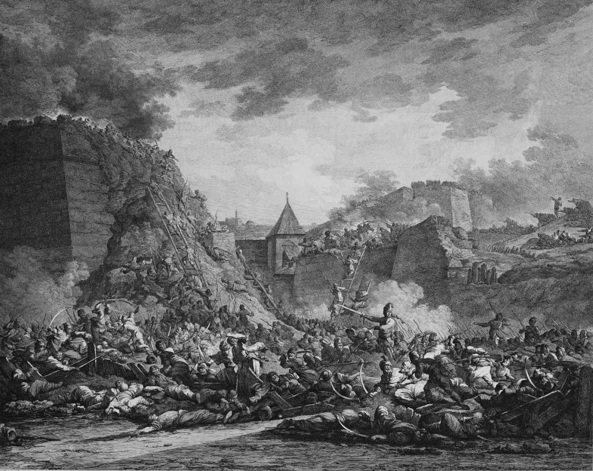 A black-and-white engraving of a battle under a stormy sky. Soldiers climb ladders up a breached stone wall while, in the foreground, a mass of fighting and fallen men in turbans and uniforms lie among broken weapons. A pointed tower and further bastions rise in the background.