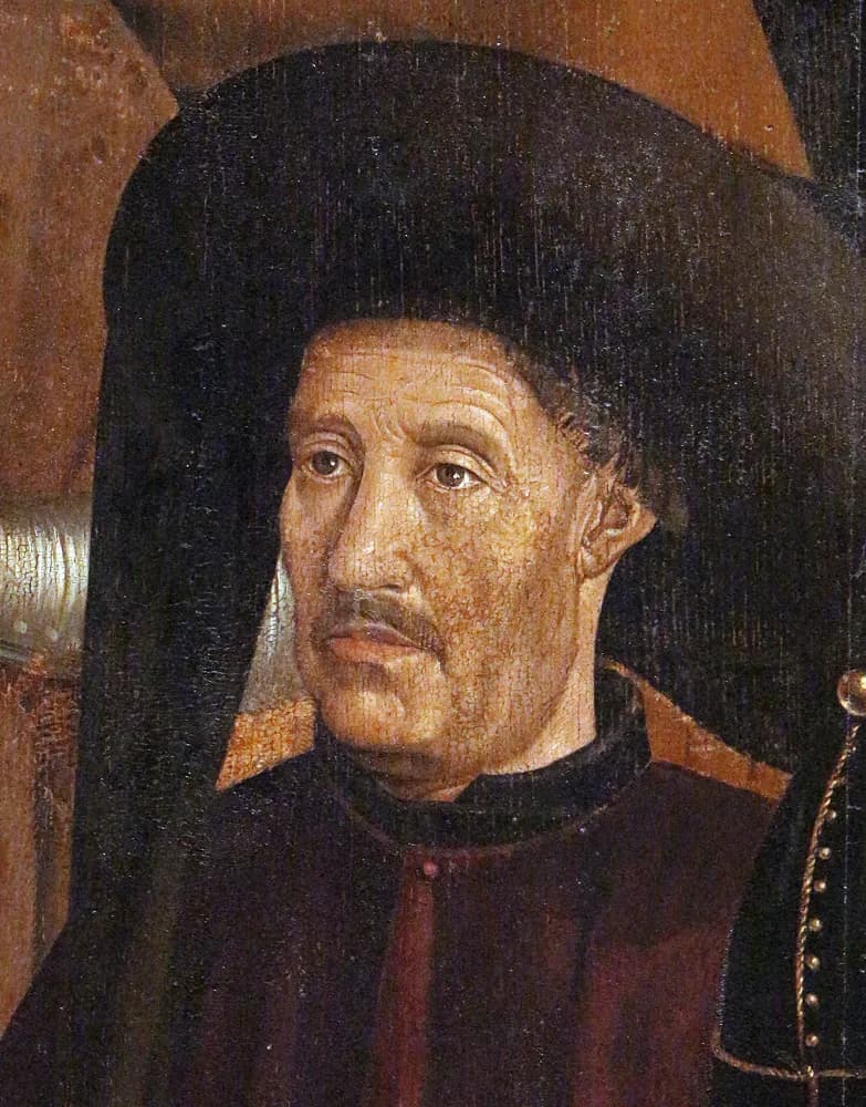 Painted detail of a middle-aged man with a thin moustache and a lined face, wearing a large black hat that falls to his shoulders and a dark red tunic.