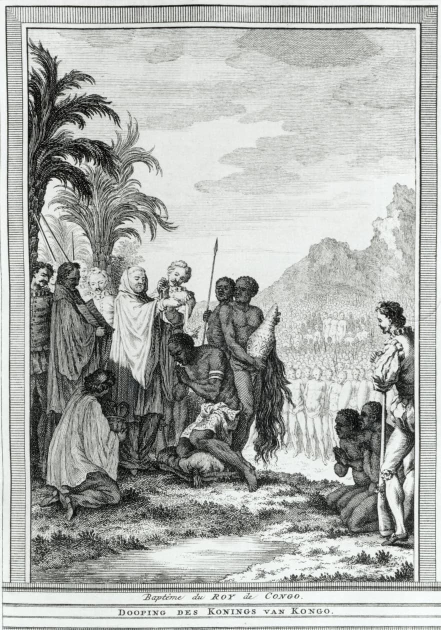 Engraving of an outdoor baptism under palm trees: a robed priest pours water over a kneeling African man, European soldiers and a page look on, and a crowd of Africans stands in the background beneath a mountain.