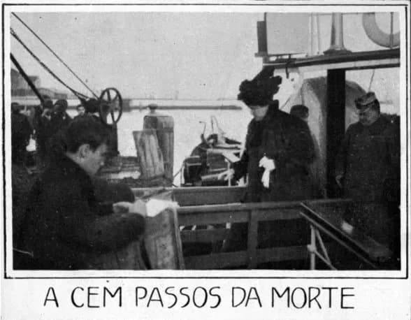 A woman in a long dark coat and a large dark hat, holding white gloves, steps from a steamer's deck towards a wooden landing stage. Men in caps and dark coats stand around her, and a young man in the foreground looks down at something in his hands.