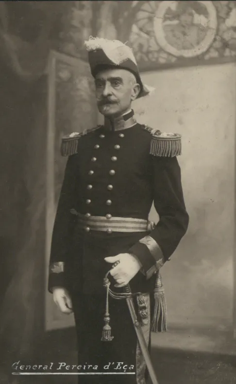 Studio portrait of an elderly moustached general standing in full dress uniform with a plumed bicorne hat, epaulettes and a sword; the name General Pereira d'Eça is written along the bottom.