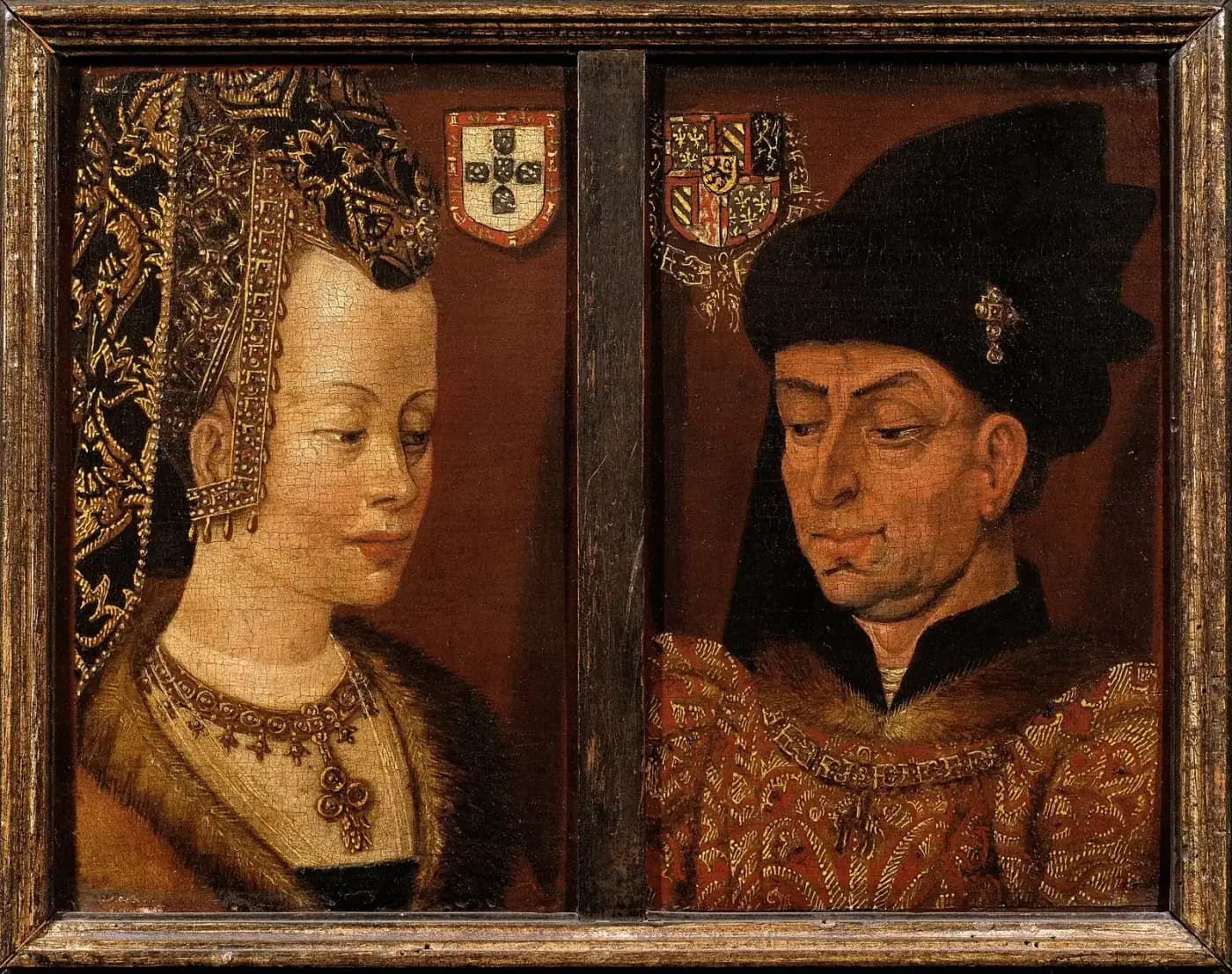 Two small portraits side by side in one wooden frame. On the left a pale young woman in a tall black and gold headdress and a jewelled necklace looks down to the right, under a shield with the Portuguese arms. On the right a heavy-featured man in a black hat and a red and gold robe looks down to the left, under a shield with the arms of Burgundy.