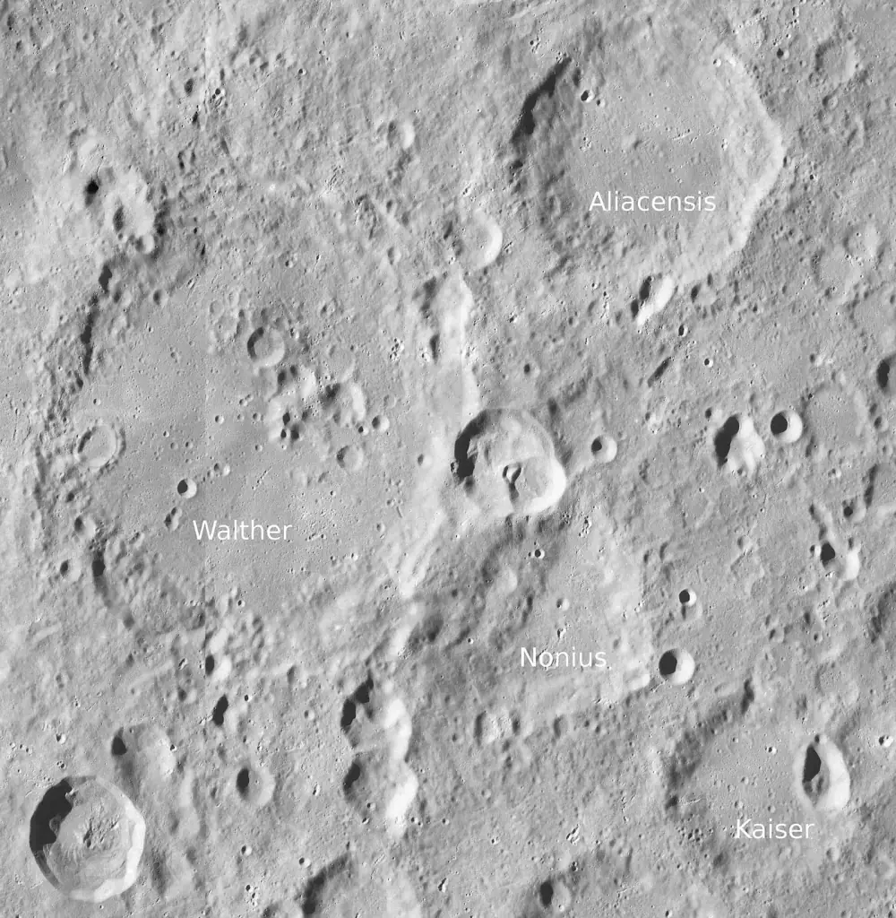 A grey cratered stretch of the Moon's surface seen from above, with four large worn craters labelled Aliacensis, Walther, Nonius and Kaiser.