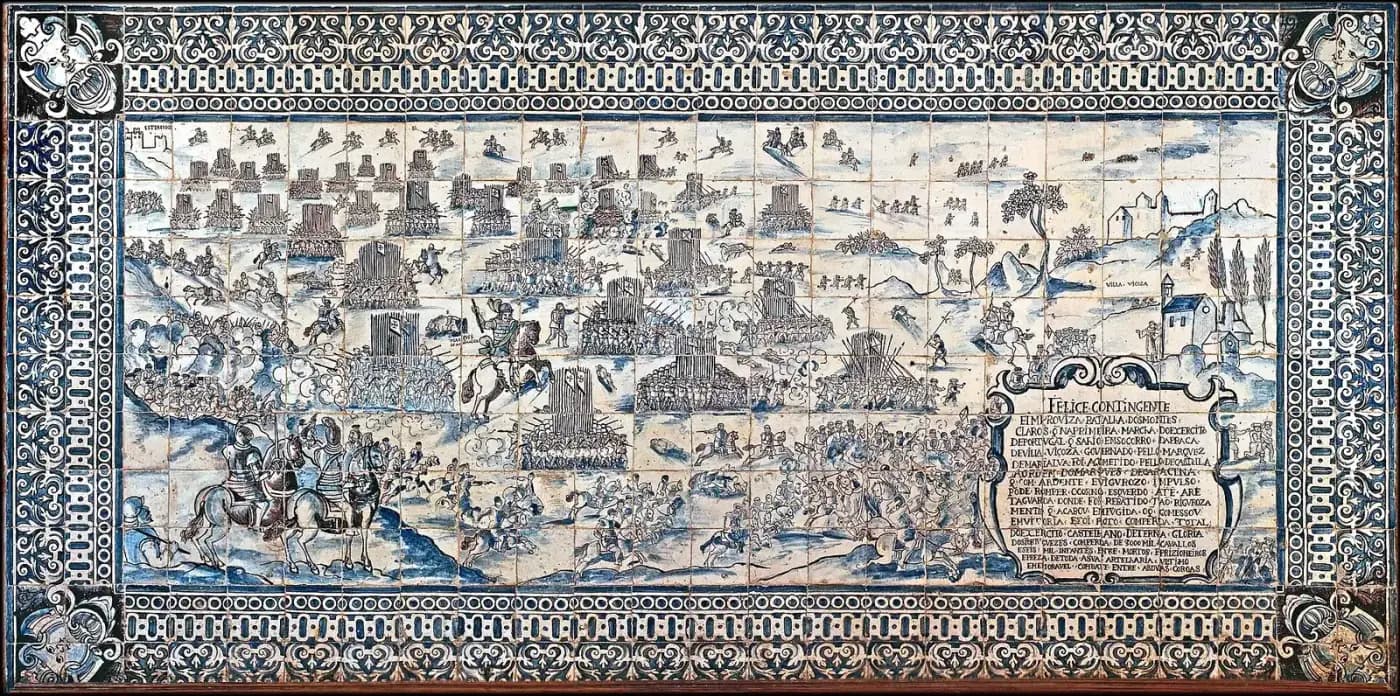 A wide blue-and-white tile panel inside a patterned border, showing a battlefield seen from above: blocks of pikemen bristling with pikes, cavalry charging, a commander on a rearing horse, a town and church on a hill to the right and a cartouche of text in the lower right corner.