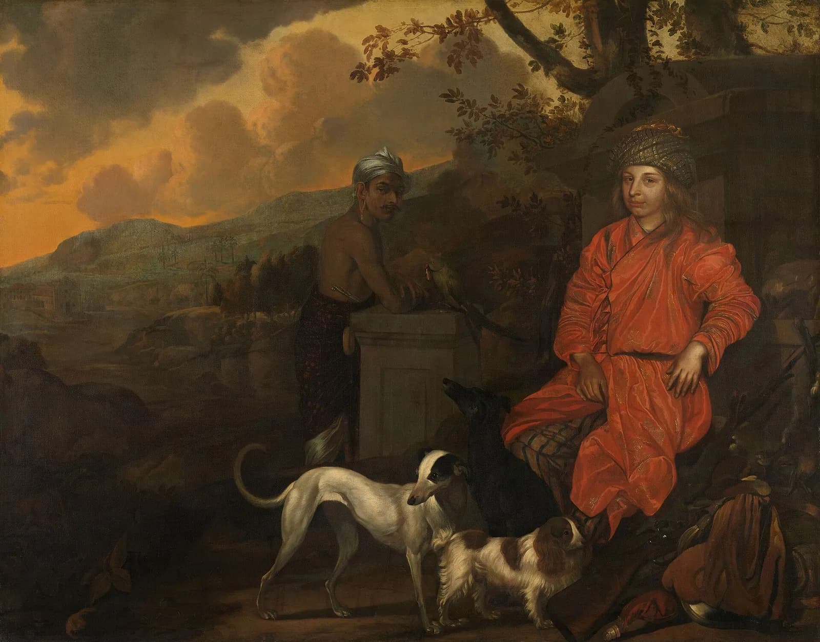 Oil painting of a young European man in a long red robe and patterned turban seated by a stone pedestal in hilly countryside at dusk, with three dogs at his feet. A bare-chested man in a white turban stands behind the pedestal.