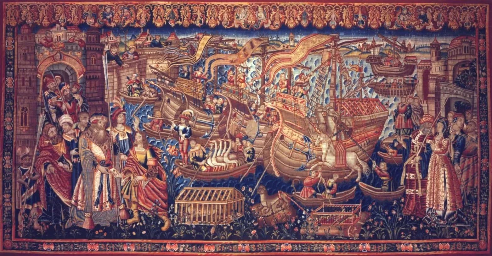 A richly coloured woven wall hanging crowded with figures: robed men with staffs and turbans on the left, tall-masted ships with streaming pennants and rowing boats in the centre, camels, a white horse and wooden cages along the shore, and towers and town walls at both ends.