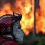 Portuguese firefighters battle intense wildfires in Spain